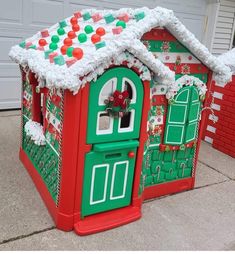 two christmas themed houses are on the sidewalk