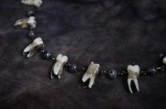 Handmade resin cast human teeth, black chain necklace with with yooperlite stone beads that glow like fire under black light. ADORN YOURSELF WITH DARKNESS! This necklace is part of the "GNASHING OF THEETH" collection handcrafted with love and profanity. Human Teeth Jewelry, Teeth Necklace, Black Chain Necklace, Human Teeth, Fire Stone, Teeth Jewelry, Fire And Stone, Black Chain, Black Light