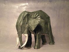 an origami elephant is standing in the studio with it's tusks curled up