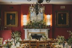 a dining room filled with lots of tables and chairs next to a fire place covered in flowers