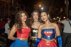 three women dressed in costumes posing for the camera