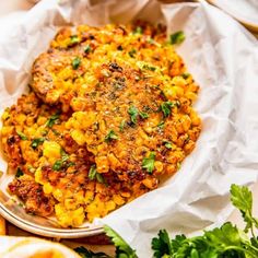 two chicken patties covered in corn and parsley