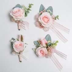 three pink flowers are placed on the same boutonniere as two other bouquets