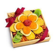 a wooden box filled with assorted fruits, nuts and dried fruit in the shape of a flower