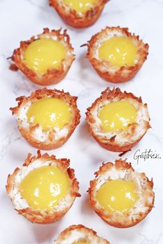 mini egg cups are arranged on a marble counter top, ready to be eaten for breakfast