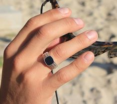 This simple men's signet ring is made of sterling silver and black square onyx stone.  On the sides of the band there are some geometrical lines in oxidized. This nice Onyx ring is a classic that matches perfectly with any look.Look around – the world is made of geometric shapes, forms, patterns and combinations of them all. Geometry is displayed in our physical world everywhere – architecture, art, fashion and much more. The spiritual world takes geometry to a new level; its language is rich in Luxury Men's Onyx Signet Ring, Luxury Black Onyx Men's Ring, Luxury Onyx Men's Engagement Ring, Luxury Black Minimalist Men's Ring, Luxury Minimalist Black Men's Ring, Luxury Men's Onyx Ring As A Gift, Luxury Men's Onyx Ring, Luxury Men's Onyx Ring For Gift, Luxury Silver Onyx Men's Ring