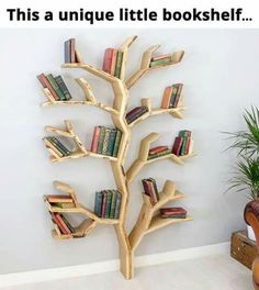 a wooden tree with books on it in front of a wall mounted bookcases