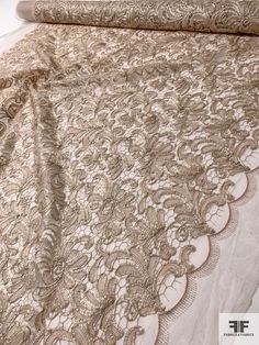 the bed is covered with an intricately designed bedspread