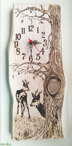 a wooden clock with an image of two deer in the woods