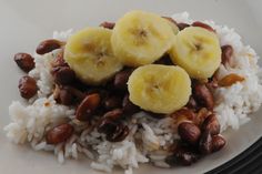 rice, beans and bananas are served on a plate