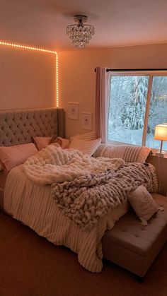 a bedroom with a large bed covered in blankets