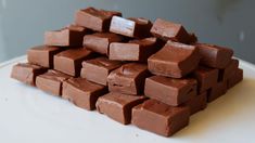 a pile of chocolate cubes sitting on top of a white plate