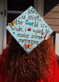 a woman wearing a graduation cap that says life is short the world is wide, i want to make some memories