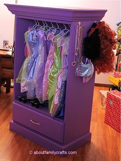 a purple armoire with clothes hanging from it's sides and the words transform an old dresser into a dress - up station