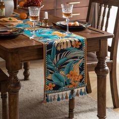 a dining room table set for two with place settings and fruit on the table top