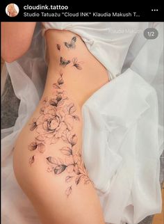 a woman's stomach with flowers and butterflies on it