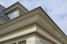 the top of a house with a skylight on it's roof and windows