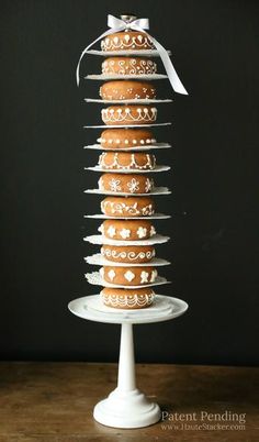 a stack of donuts sitting on top of a cake plate