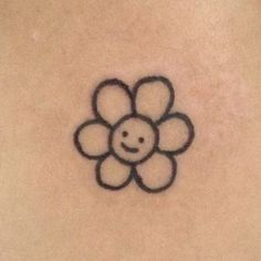 a smiley face drawn on the back of a woman's stomach