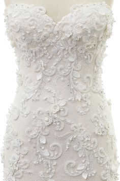 a white wedding dress on a mannequin with floral appliques and beading