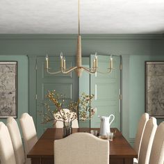 a dining room table with white chairs and a chandelier