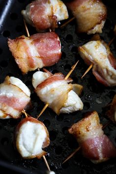 bacon and cheese skewers are being cooked in a skillet