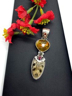 Artisan Fossil gemstone pendant  Hand-made Sterling Silver 925  Stones used: Baltic Amber, Ammonite-Fossil, Ruby, Pearl,    Garnet, Citrine  Height - 2 3/4” (with bail), Width - 3/4”Unique Handcrafted One-of a-kind Design PendantEach Piece of Jewelry in my Collection is Absolutely One of a Kind!When you start wearing a piece of my jewelry you will fall in love with it more and more each day and feel that good Energy and Love that I pass into it while creating this piece of Art.A piece of Art cre Pink Sapphire Pendant, Artisan Necklace, Ammonite Fossil, Antique Pendant, Charm Necklace Silver, Sapphire Pendant, Handcrafted Necklace, Statement Pendant, Metal Work