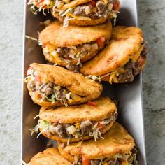 some tasty looking food is on a metal platter and ready to be eaten