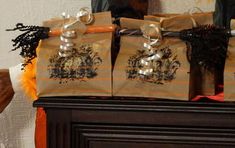 three brown bags sitting on top of a wooden table next to a fire place and mirror