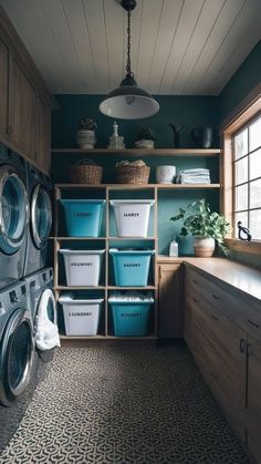 a washer and dryer in a laundry room with wooden shelves, blue bins and baskets