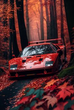 a red sports car parked on the side of a road surrounded by trees and leaves