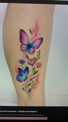 a woman's leg with butterflies and flowers on it