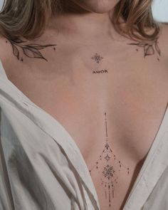 a woman with tattoos on her chest