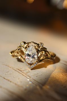 a close up of a gold ring with a diamond on it's center stone