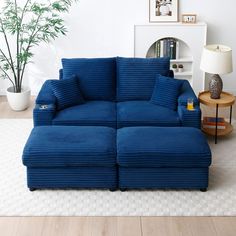 a large blue couch sitting on top of a hard wood floor next to a table