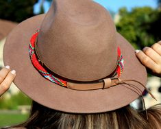 Dress up any hat with this western beaded leather hat band. Beautiful native and Navajo patterns with vibrant colors. Bring a southern charm to your old favorites with this gorgeous hat band or make your new hat even more special. Made of full grain leather (highest grade leather) and glass beads. Handmade in Brazil by artisan women. You can match your hat band with our best-selling leather beaded dog collars! Treated with beeswax, water resistant. 30 days free returns or exchange. 1-year warran Handmade Red Hat Bands For Rodeo, Red Bohemian Hat Bands For Festivals, Bohemian Red Hat Bands For Festival, Bohemian Festival Red Hat Bands, Bohemian Festival Hat Bands In Red, Red Handmade Adjustable Hat Bands, Artisan Red Hat Bands For Festival, Adjustable Handmade Red Hat Bands, Red Adjustable Country Hat Bands