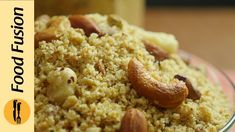 a bowl filled with rice and nuts on top of a table