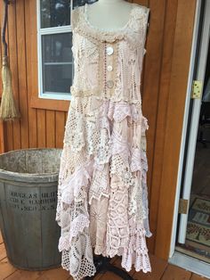 a dress on display in front of a wooden building