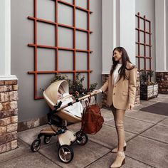 a woman standing next to a baby stroller