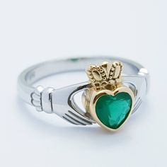 The perfect gift for you or someone close. Sterling silver claddagh ring set with green heart shaped stone with inclusions to look like genuine emerald. The hands represent friendship, the heart love and the crown stands for loyalty. This ring has been coated in a durable layer of 18k yellow gold, to maintain the color as long as possible please avoid contact with chemicals, lotions etc and keep in an airtight zip lock bag when not being worn. ---------------------------------------------------- Fine Jewelry Green Heart Ring For May Birthstone, Fine Jewelry Green Heart Shaped Ring, Green Heart Ring For May Birthstone, Fine Jewelry Style, Green Heart Ring For May Birthstone, Green Heart-shaped Fine Jewelry Ring, Classic Green Heart Cut Rings, Formal Green Heart Cut Rings, Green Gemstone Heart Ring For May Birthstone, Heart Cut Green Emerald Ring For Formal Occasions