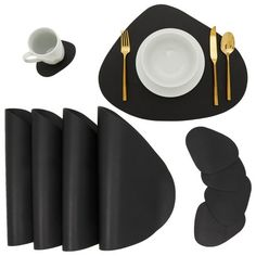 black and white place setting with goldware, napkins, cups and saucers