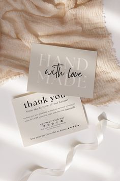 two thank cards sitting on top of a blanket