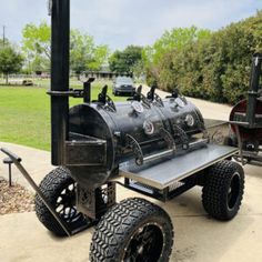 an outdoor bbq cart with four propane tanks attached to the back and wheels