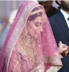 a woman in a pink bridal gown and veil