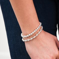 One of our classics from the beaded lux collection. Stack the alternating sized bead bracelet with a chain bracelet for a well-rounded arm party. This style is created with one of our "stretchy" cords for easy wear and effortless bracelet stacking. Bracelet is made with 4mm and 6mm alternating sterling silver beads. We want to make sure your stretch bracelet has the perfect fit, so we have created sizing options to select above. Please contact us if you have any sizing questions or would like a Sterling Silver Bead Bracelet, Acrylic Storage, Silver Bead Bracelet, Arm Party, Chains Necklaces, Pendant Bracelet, Storage Container, Sterling Silver Bead, Bead Bracelet