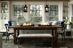 a dining room table with candles on it