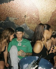 three people sitting next to each other at a party