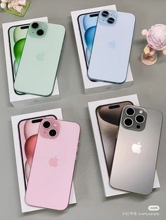 three new iphones are in their boxes on the table