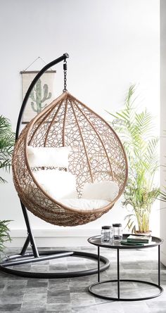 a living room with a hanging chair and coffee table