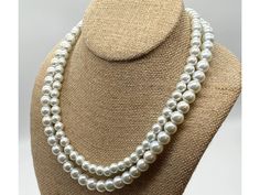 Introducing the epitome of timeless beauty, the Classic 2 Strand Pearl Necklace of Elegance! This exquisite necklace effortlessly combines classic charm with a modern twist, making it the perfect accessory for any special occasion. Crafted with two strands of genuine glass pearls, this necklace exudes an aura of elegance and sophistication that is simply unmatched. Whether you're heading out for a romantic dinner or attending a glamorous event, this timeless piece is guaranteed to elevate your o Classic Jewelry With Large Round Beads, Classic Wedding Necklace With Lobster Clasp, Large Beads Pearl Necklace As Gift, Pearl Necklace With Large Beads As Gift, Pearl Necklace With Large Beads For Gift, Classic 8mm Beads For Jewelry Making, Elegant Necklace With Large Round Beads, Classic Jewelry With Lobster Clasp And Round Beads, Classic Double Strand Beaded Necklaces